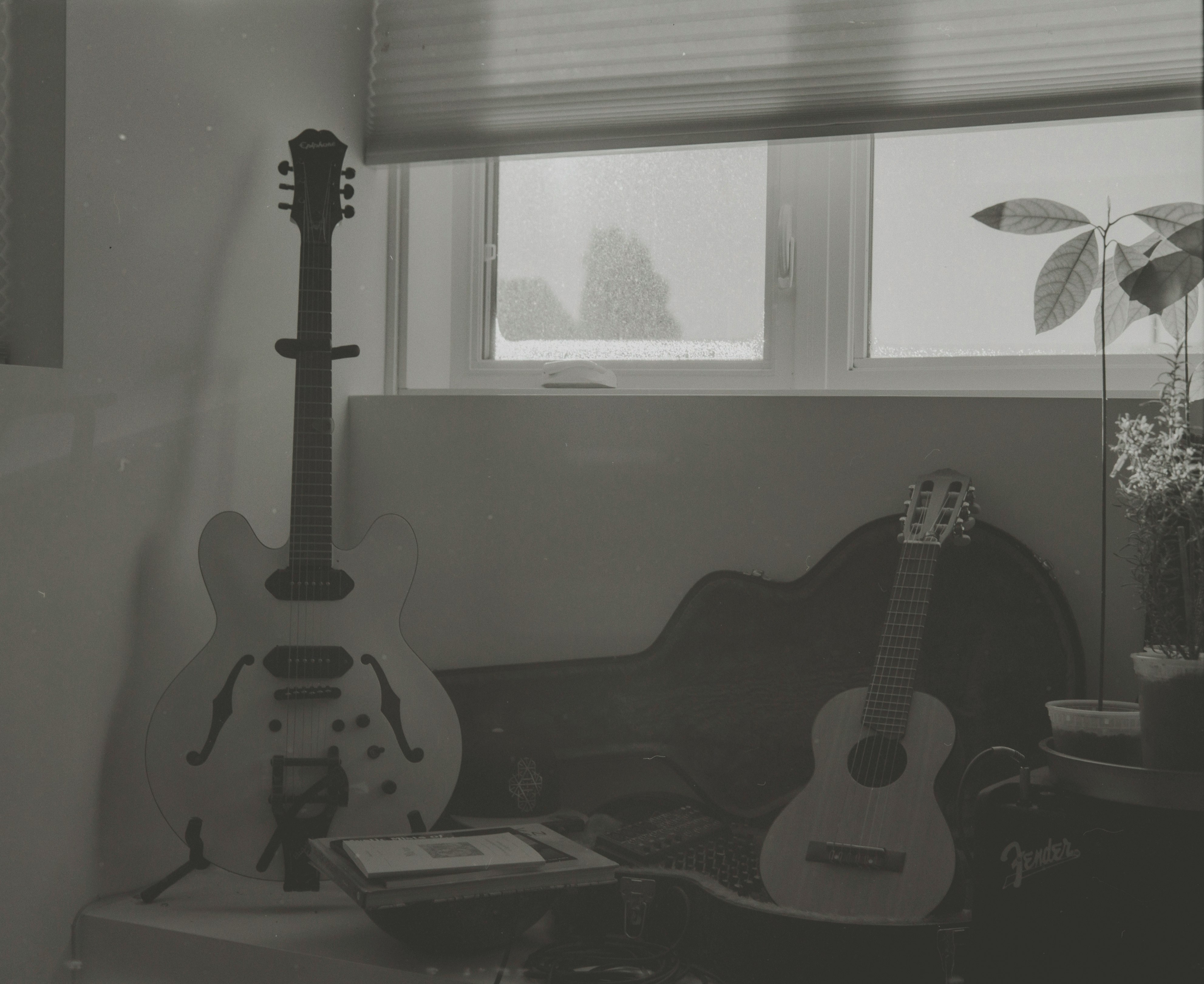 two guitars leaning on chairs and table inside room